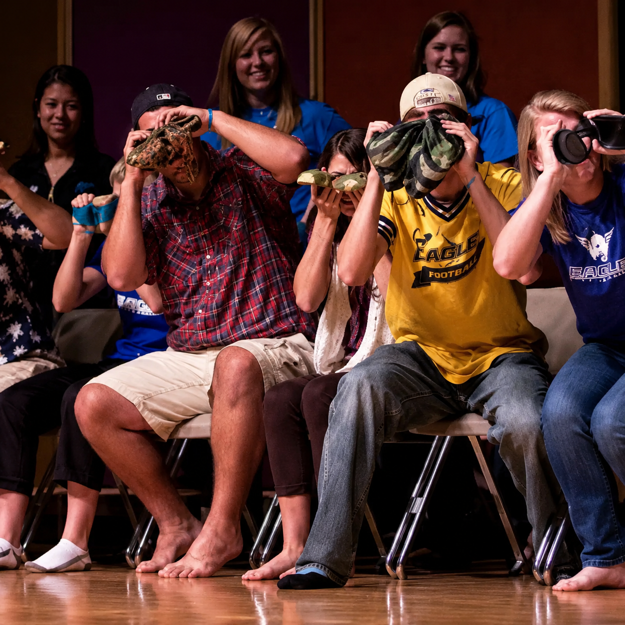 Stage hypnosis show audience reacting during a live performance
