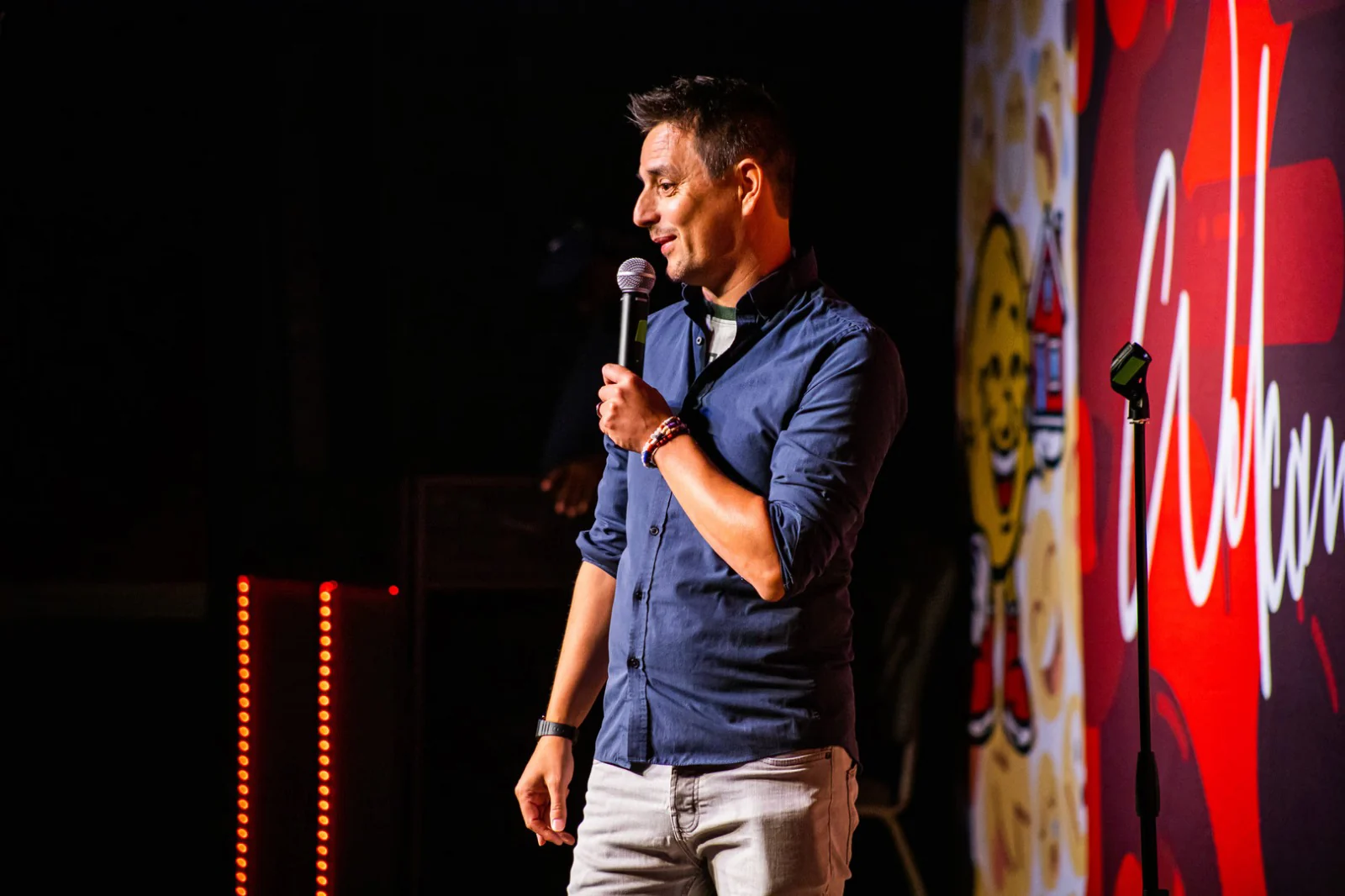 Michael C. Anthony performing a live stage hypnosis show with a microphone